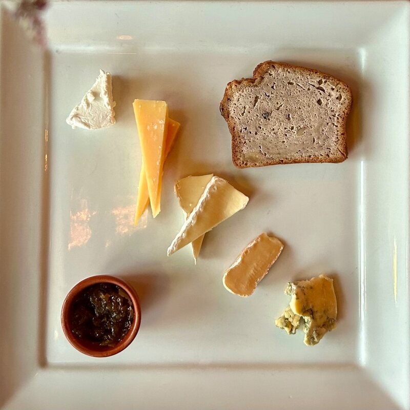 Kaasplankje met vier soorten kaas, huisgemaakt brood en vijgenchutney